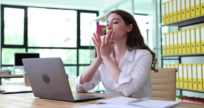 Serious business woman working at office desk with laptop is nervous and waiting for interview. Worry about financial matters
