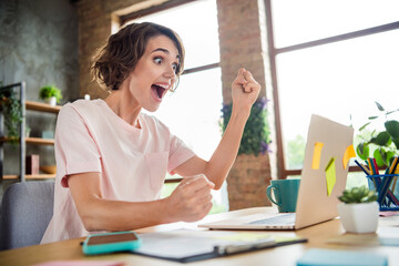 Photo of crazy young girl fists up watching netbook results she approved her first vacancy winner good job isolated indoors background
