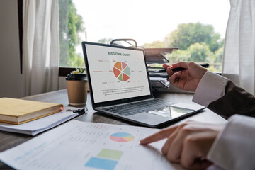 Businessman hands are analyzing charts, graphs, financial data. and accounting documents The displayed data calculates the planning strategy
