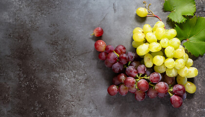 Red and white grapes over stone table. Top view with copy space