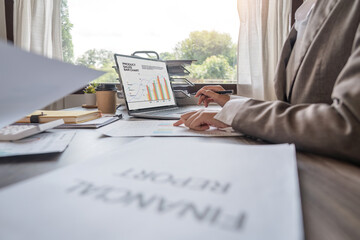 Two male accountants use calculator to calculate the company financial results with finance and and analytical research, income, tax and business growth