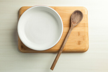 Plate of food on the table with a wooden cutting board. Space for text. Copy space.