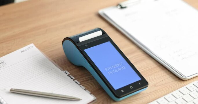 Closeup of wireless modern bank payment terminal for processing and receiving credit card payments. Approved bank payment