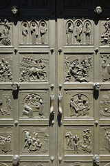 Sculpted scenes in large metal church entrance door. Close up shot, no people