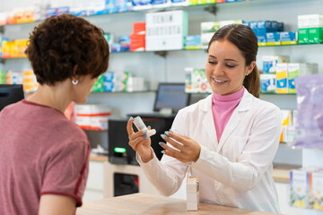 A female pharmacist talking with a female customer about a products choice - obrazy, fototapety, plakaty