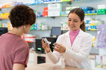 Zelfklevend Fotobehang A female pharmacist talking with a female customer about a products choice © Marc Calleja