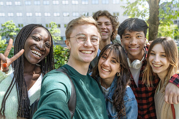 Multicultural Teenagers Taking a Selfie at School Park - Diverse teens with backpacks smile while...