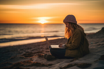 A joyful woman works on a laptop at sunrise on a beach. Warm light illuminates her content expression. The pastel colors of the ocean complement her vibrant attire. Generative ai.