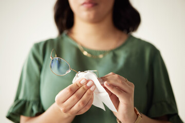 Woman, hands and clean the dust on glasses for heathy vision with cloth for protection. Eye, care...