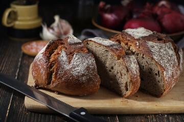 A loaf of rye bread in low key	