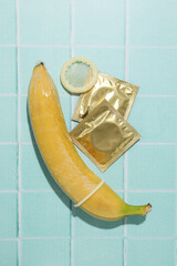 Condoms on bananas on a blue background
