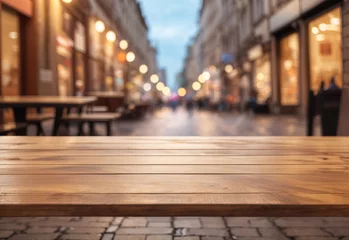 Fotobehang Empty wooden table with blurred street background © Zahfran