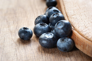 Blueberry. Fresh blueberries on a wooden surface close-up. Sprinkle blueberries. Scattered fresh blueberries. Fresh organic food. Healthy food concept. Selective focus