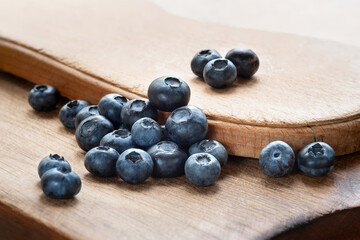 Blueberry. Blueberries on a wooden surface close-up. Sprinkle blueberries. Scattered fresh blueberries. Fresh organic food. Selective focus