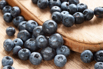 Blueberry. Fresh blueberries on a wooden surface close-up. Sprinkle blueberries. Scattered fresh blueberries. Organic food. Selective focus