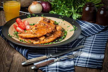 Potato pancakes with meat, vegetable, tomato and parsley.