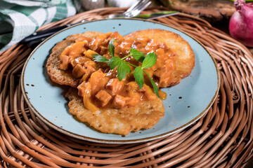 Homemade potato pancakes with goulash.