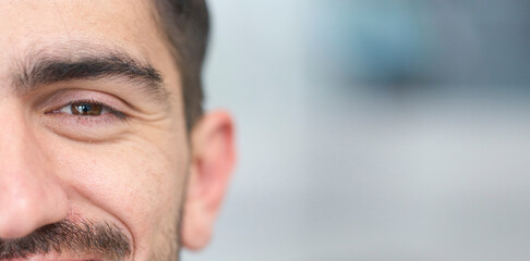 Face, eyes and mockup with a man closeup for future vision or eyesight while looking happy or positive. Portrait, half and space with a young male person on a mock up banner for optometry or eye care