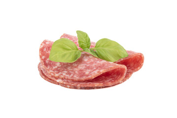 Sliced smoked sausage and green basil on a white background.