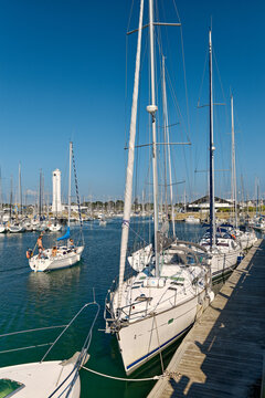 Pleasure boats yachts in Port du Crouesty marina in Baie de Quiberon, Brittany, France. Looking toward lighthouse and Yacht Club