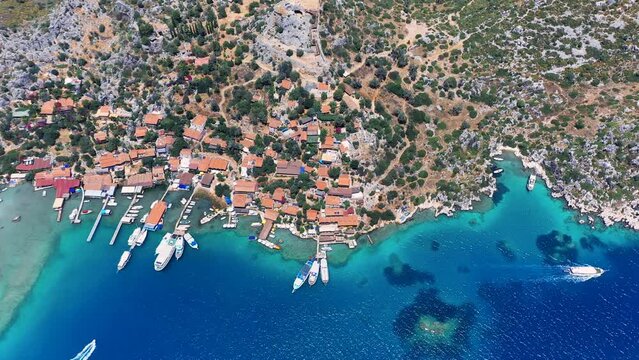 Aerial top down view of Ancient village of Simena beach and yachts, display the historic site and enchanting Mediterranean landscape in Turkey. Daily tour boats stop for a max of 1 hour at village
