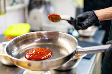 Tomato Sauce with Spoon in Metal Pan