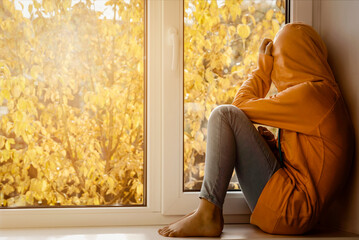 Sad Stressed Along Upset Depressed Unhappy Teen in Autumn Yellow Window Background. Adolescent...