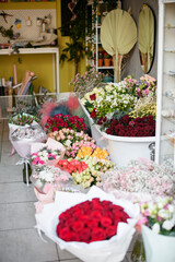 Flower shop inside interior. Flowers bar with variety of beautiul fresh flowers and packing materials for customer's compositions