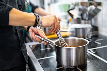 Chef cook hand cooking food at the restaurant kitchen