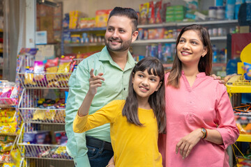 Happy Indian family at grocery shop.