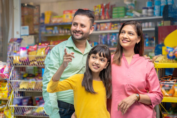 Happy Indian family at grocery shop.