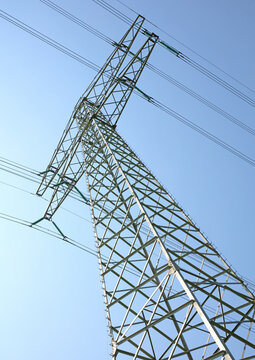 View on one outdoor high voltage electric transmission line support metal construction tower pillon