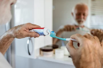 Fotobehang Schoonheidssalon Cleaning, mouth or hand brushing teeth with dental toothpaste for healthy oral hygiene grooming. Eco friendly, senior man with a natural toothbrush for teeth whitening.
