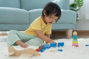 Happy Asia children play and learn toy blocks.family is happy and excited in the house. daughter...