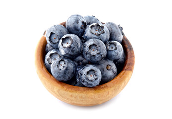 Blueberries Isolated on White Background. Ripe berries closeup in wooden bowl.  Berries with drops of water. Top view.