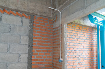 Electrical conduit, and wires are installed in a house wall getting ready