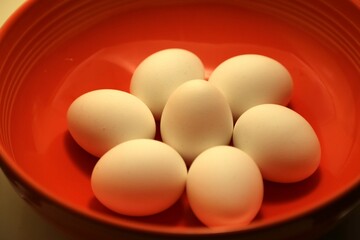 Close-up of eggs in an orange bowl