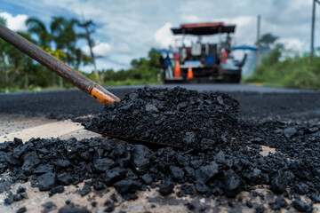 Asphalt in the shovel after the asphalt dumper has passed