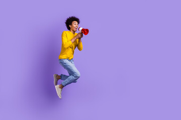 Fototapeta na wymiar Full length size view photo of funny crazy man jumping with megaphone loudspeaker proclaim announce isolated on violet color background