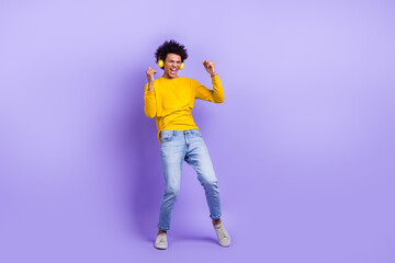 Full body photo of cheerful carefree person ecstatic listen music headphones dance empty space isolated on violet color background