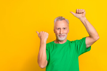 Photo of satisfied aged person indicate thumb fingers empty space news blank isolated on bright yellow color background