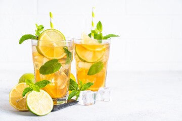 Iced tea with lemon, lime, mint and ice.