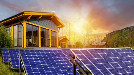 Solar batteries on evening lawn. Alternative sun batteries near house. Power plant. Solar panels in...
