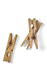 Three wooden dilapidated clothespins isolated on white background. Top view with copy space