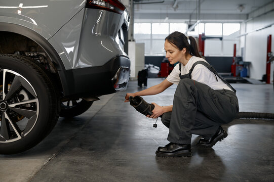 Woman Mechanic Testing Car Traffic Fumes Emission