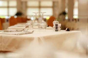 Preparing tableware in restaurant interior by waiter