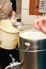 Close shot for proces of making and shaping soft, white cheese, no face