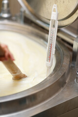 Close shot for proces of making and shaping soft, white cheese, no face