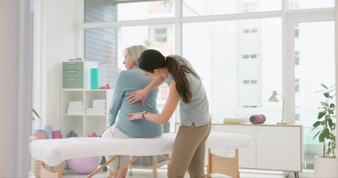 Woman, physiotherapist and rehabilitation of senior patient, medical advice and helping arthritis. Physiotherapy, healthcare assessment and chiropractor check back muscle on body for healing injury