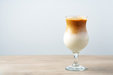 Ice coffee cocktail in glass with ice on table
